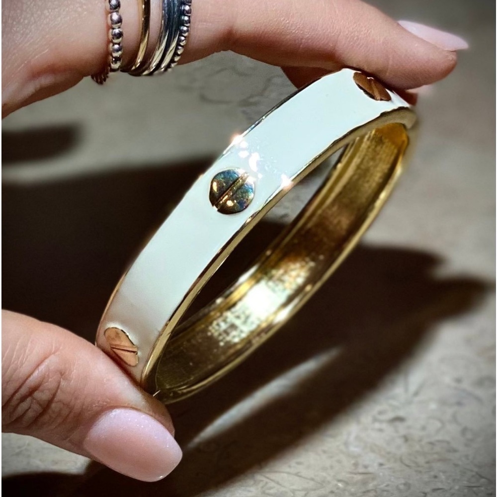 Gold tone designer style love bangle bracelet with white enamel gold screws